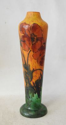 a vase with a painting on it sitting on a table