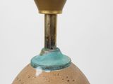 a brown vase with a blue top on a table