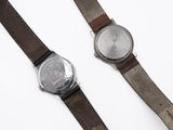 an image of a couple of watches sitting on top of a table