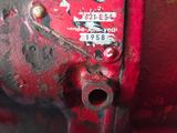 a red fire hydrant that has a sign on it