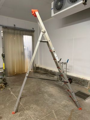 a ladder in the middle of a room that is being remodeled