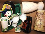 a cardboard box with a variety of vases in it