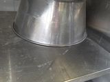 a large metal pan sitting on top of a metal counter