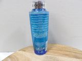 the bottle of water is sitting on a wooden table