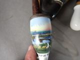 someone is holding a wine glass with a picture of a bridge on it