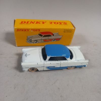 a toy car that is sitting next to a box