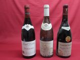 three bottles of wine are lined up on a red background