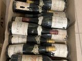 bottles of wine in a cardboard box on a tiled floor