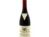 a bottle of red wine sitting on top of a white table