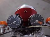 two gauges on the handlebars of a motorcycle