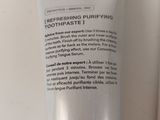 a close up of a tube of toothpaste next to a tube of toothpaste