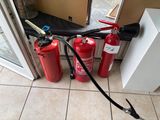 two fire extinguisors on the floor next to a door
