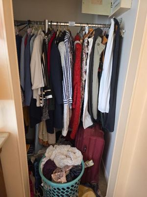 an image of a closet full of clothes and clothes
