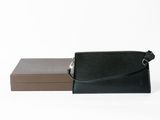 black and brown leather wallet and box on a white surface