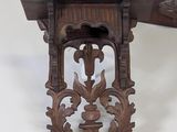 a wooden shelf with a clock on top of it