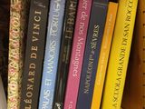 many books that are on a book shelf together