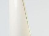 a white vase with a triangular shape on a white surface