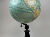 a small blue and green globe on a black stand