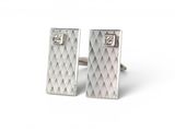 pair of silver cufflinks with diamonds on them on a white background