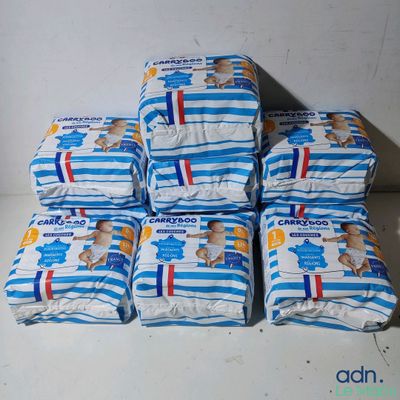 several packs of diapers stacked on top of each other on a table