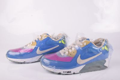 une paire de baskets Nike Air Max bleues et roses sur fond blanc