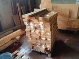 a pile of wood in a warehouse with a lot of pallets