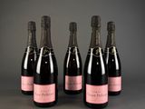 six bottles of champagne are lined up in a row