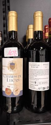 many bottles of wine sitting on a shelf in a store