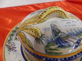 a plate with a lid that has a picture of a woman on it