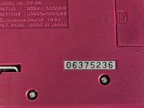 an image of a pink electronic device on a white surface