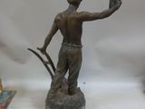 a statue of a man holding a bird in his hand