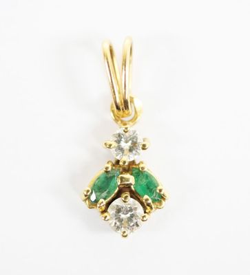 an emerald and diamond pendant on a white background