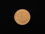 a close up of a gold coin on a black background