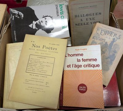 many books that are in a box on a table