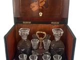 a wooden case with a set of glassware in it
