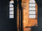 two windows in a brick building with a light coming through them