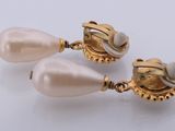pair of pearl and gold earrings on a white background