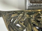 a close up of a sword with a skull on it