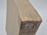 an old book sitting on top of a wooden table