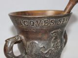 a metal cup with a wooden spoon in it
