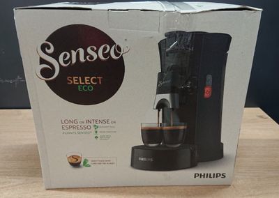 packaging of a coffee maker sitting on top of a wooden table
