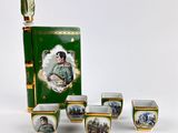 five cups and a box with a picture of a woman