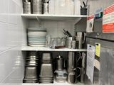 many pots and pans on the shelves in the kitchen