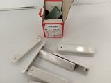 several pieces of white plastic are in a box on a white surface