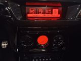 a digital clock on the dashboard of a car