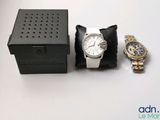 une montre et un coffret à montre posés sur une table