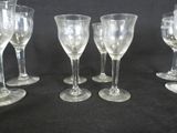 several empty wine glasses are lined up on a black surface