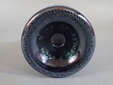 a black glass bottle with a hole in the middle