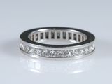 a close up of a diamond ring on a white surface