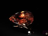 an orange diamond on a black surface